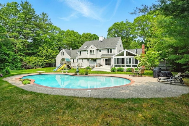 105 Old Barn Path, Marshfield, MA 02050 - back of house featuring a sunroom, an outdoor pool, a chimney, a playground, and a patio area