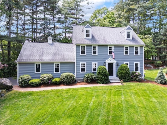 28 Old Farm Rd, Hopkinton, MA 01748 - colonial home featuring a front lawn, a chimney, and roof with shingles