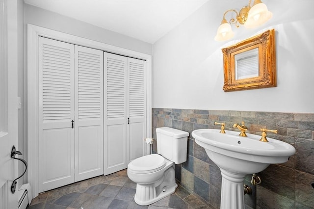 28 Old Farm Rd, Hopkinton, MA 01748 - bathroom with a closet, toilet, stone tile floors, a baseboard radiator, and wainscoting