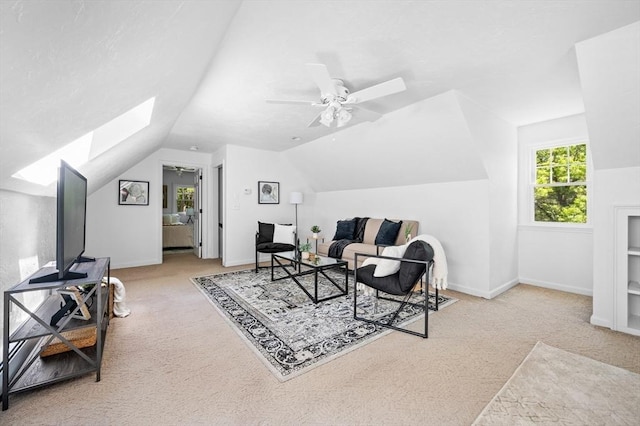 28 Old Farm Rd, Hopkinton, MA 01748 - sitting room with carpet floors, vaulted ceiling, a skylight, ceiling fan, and baseboards
