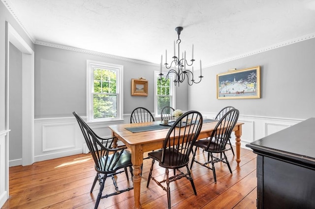 28 Old Farm Rd, Hopkinton, MA 01748 - dining space with light wood-style floors, a chandelier, a wainscoted wall, ornamental molding, and a decorative wall