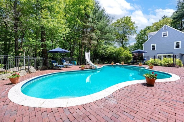 28 Old Farm Rd, Hopkinton, MA 01748 - view of swimming pool with a water slide, a patio area, and view of wooded area