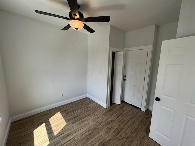 110 Old Harbor St, Boston, MA 02127 - unfurnished bedroom with dark wood-type flooring, baseboards, and a ceiling fan