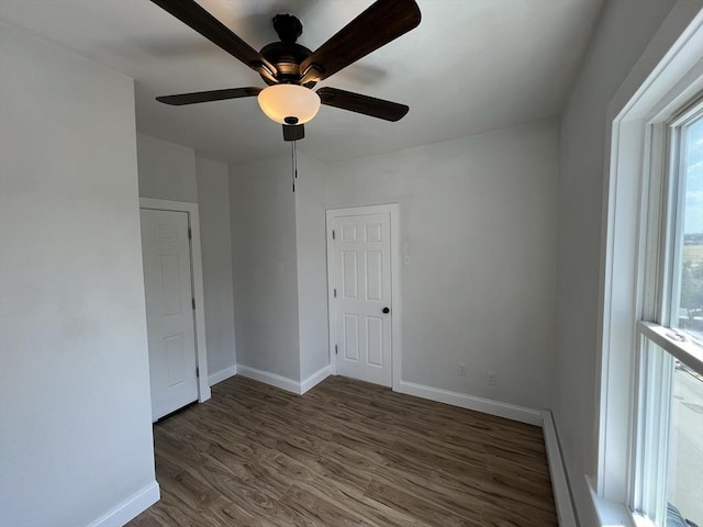 110 Old Harbor St, Boston, MA 02127 - empty room featuring baseboards, wood finished floors, baseboard heating, and a ceiling fan