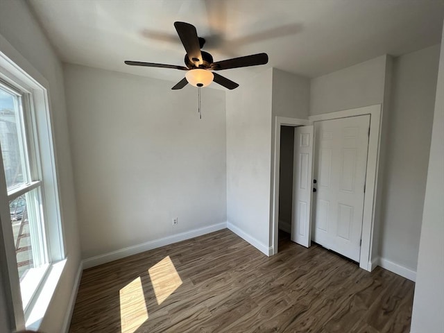 110 Old Harbor St, Boston, MA 02127 - unfurnished bedroom with dark wood-style floors, baseboards, and a ceiling fan