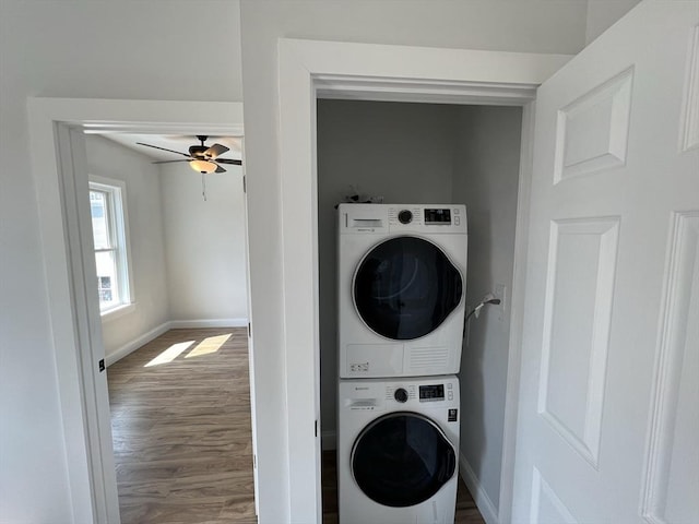 110 Old Harbor St, Boston, MA 02127 - laundry room with stacked washing machine and dryer, baseboards, wood finished floors, and a ceiling fan