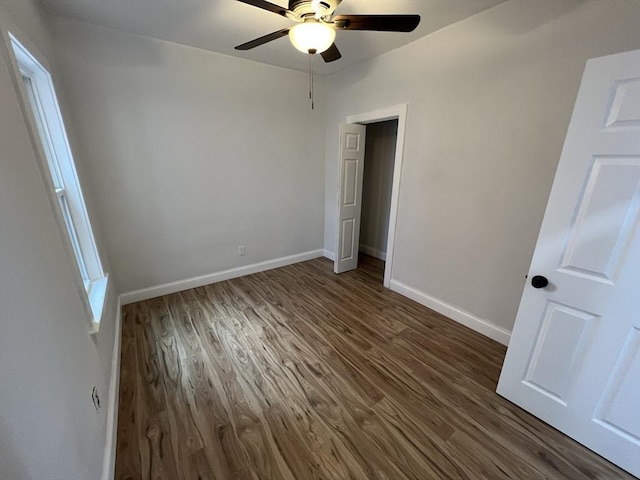 110 Old Harbor St, Boston, MA 02127 - unfurnished bedroom featuring dark wood finished floors, baseboards, and ceiling fan