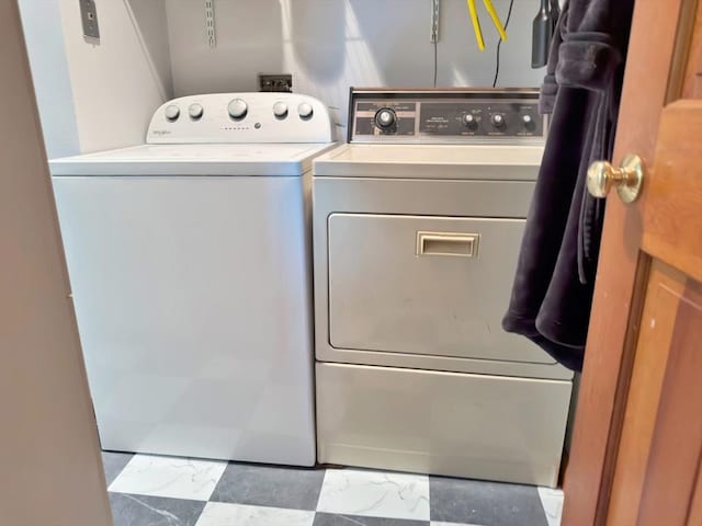 laundry area with marble finish floor, separate washer and dryer, and laundry area