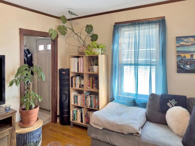 living area featuring ornamental molding and hardwood / wood-style floors