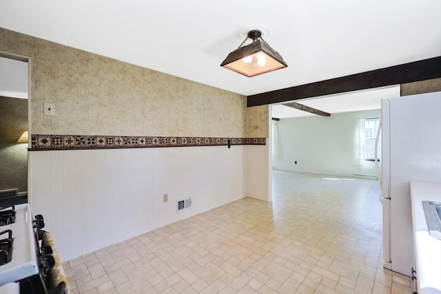 unfurnished room featuring visible vents