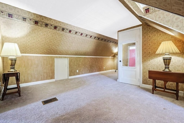 bonus room with visible vents, carpet, and wallpapered walls