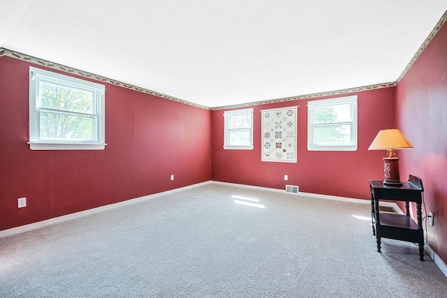 unfurnished room featuring carpet floors, baseboards, and visible vents