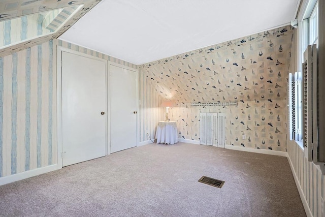 bonus room with carpet floors, wallpapered walls, and visible vents