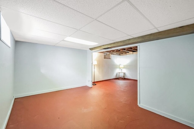 finished below grade area with baseboards and a drop ceiling