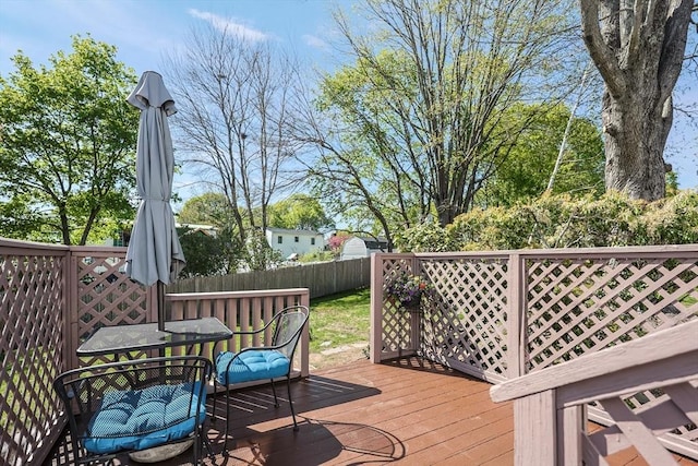 deck featuring fence and outdoor dining space