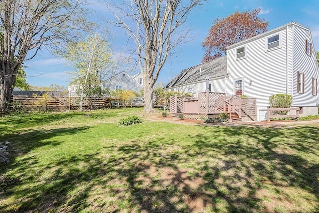 view of yard with fence and a deck