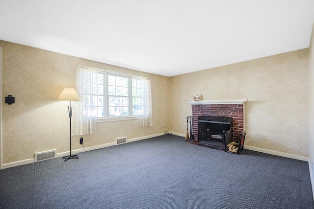 unfurnished living room with a fireplace, carpet flooring, and visible vents