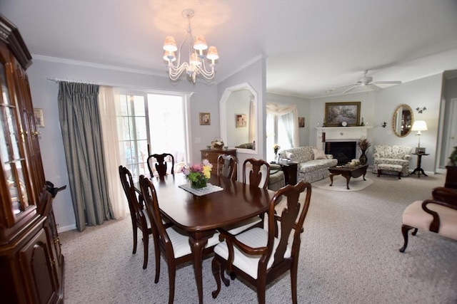 dining room featuring a fireplace, light colored carpet, and crown molding