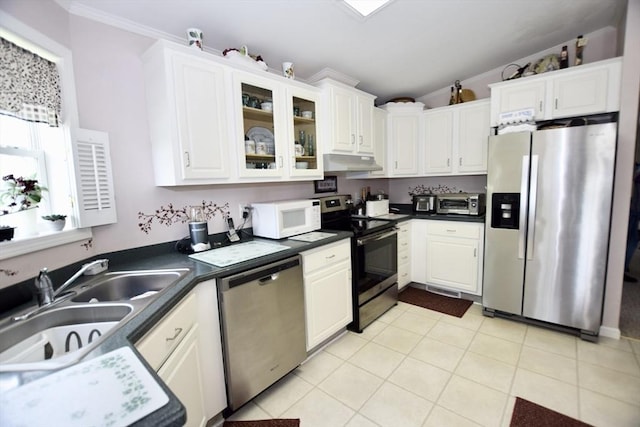 kitchen featuring white cabinets, stainless steel appliances, under cabinet range hood, and a sink