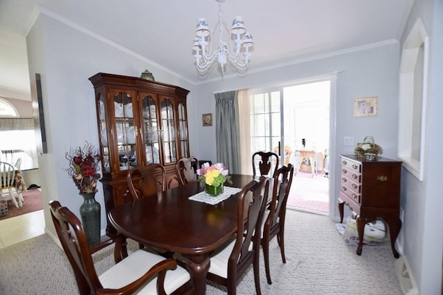dining area featuring light colored carpet, a chandelier, and crown molding