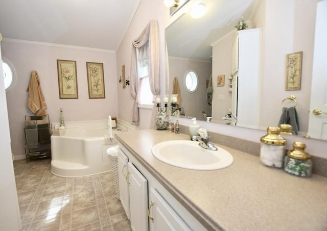 bathroom featuring crown molding, a garden tub, and vanity