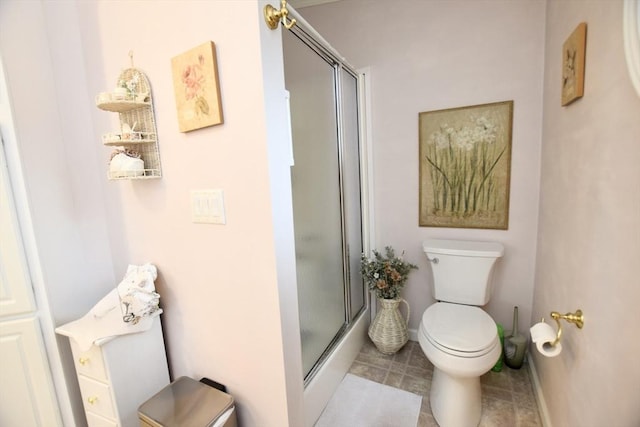 full bathroom with toilet and a shower with shower door