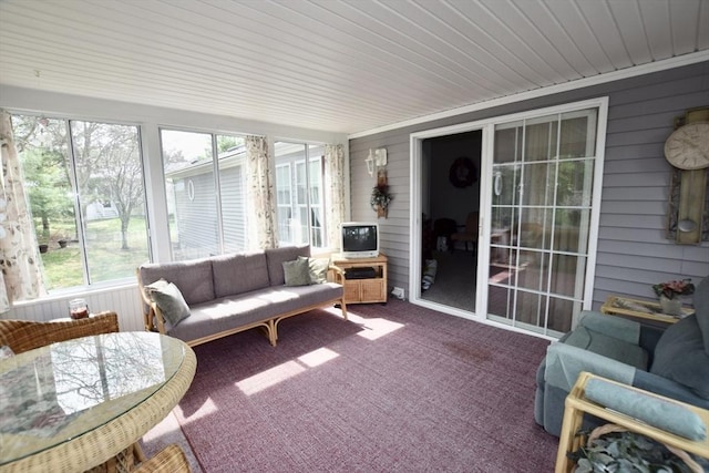 sunroom / solarium featuring wood walls, an outdoor hangout area, carpet flooring, and wooden ceiling