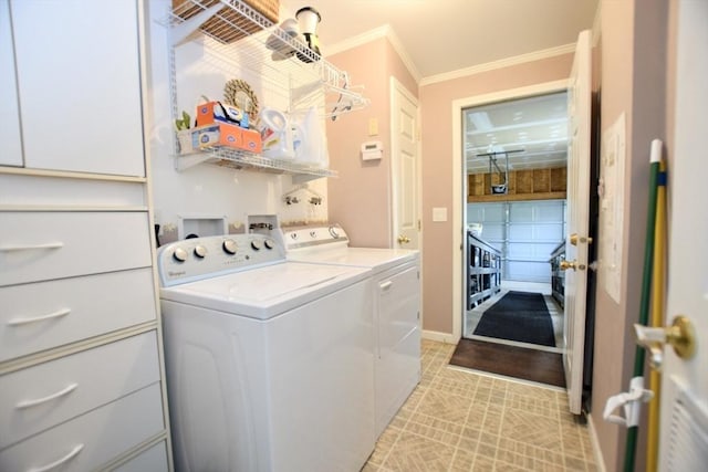 laundry room featuring baseboards, washer and dryer, and ornamental molding