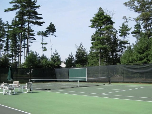 view of tennis court with fence and community basketball court
