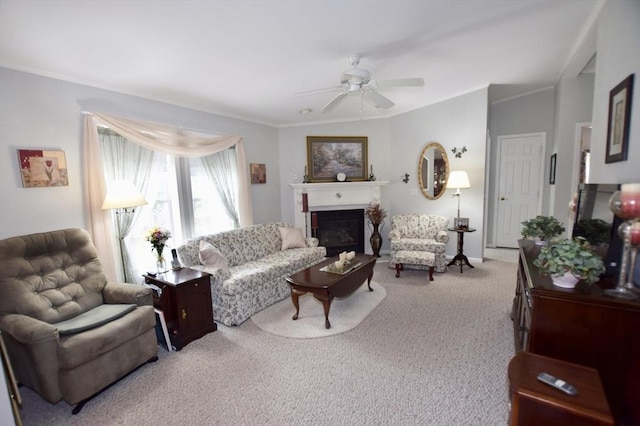 living room with ornamental molding, ceiling fan, a fireplace, and carpet flooring