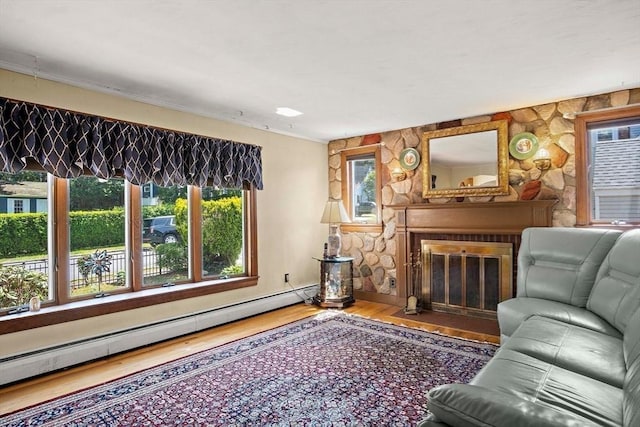 4 Merrow Ln, Stoneham, MA 02180 - living area with baseboard heating, a fireplace with flush hearth, wood finished floors, and ornamental molding