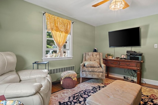 4 Merrow Ln, Stoneham, MA 02180 - living room featuring radiator, a ceiling fan, baseboards, and wood finished floors