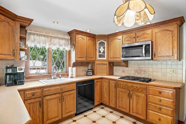 4 Merrow Ln, Stoneham, MA 02180 - kitchen with black appliances, a sink, light countertops, brown cabinets, and recessed lighting