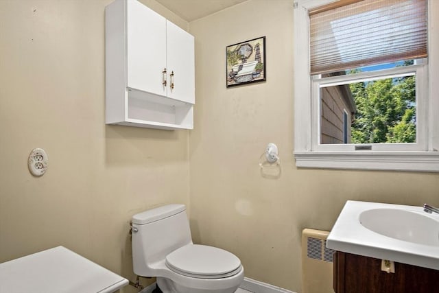4 Merrow Ln, Stoneham, MA 02180 - bathroom with radiator, toilet, vanity, and baseboards