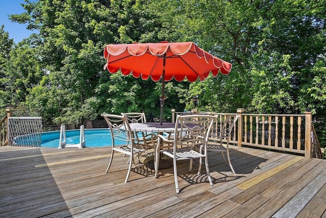 4 Merrow Ln, Stoneham, MA 02180 - wooden terrace featuring outdoor dining area, an outdoor pool, and view of wooded area
