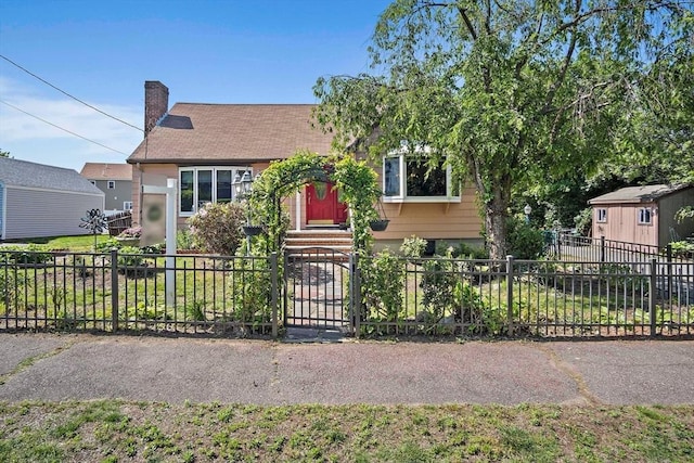4 Merrow Ln, Stoneham, MA 02180 - view of property hidden behind natural elements featuring a fenced front yard, a chimney, and entry steps