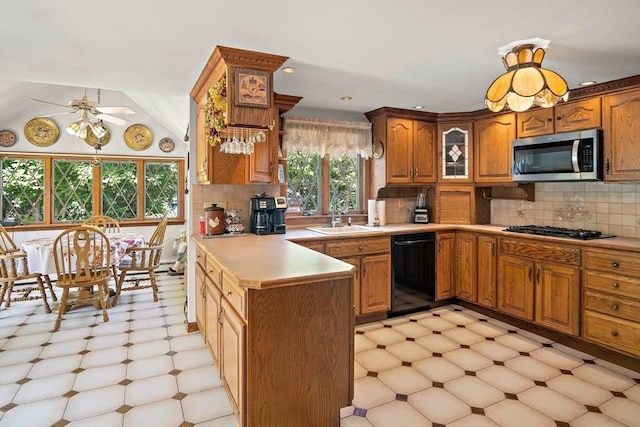4 Merrow Ln, Stoneham, MA 02180 - kitchen with black appliances, a sink, a ceiling fan, brown cabinets, and a peninsula