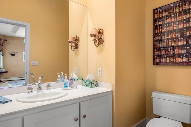 bathroom with vanity, toilet, and baseboard heating