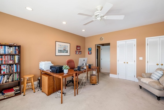 office area featuring light carpet and ceiling fan