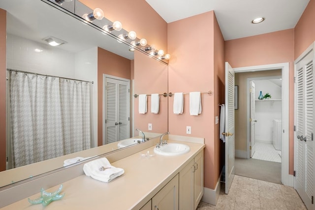 bathroom with vanity, washer and clothes dryer, tile patterned flooring, and walk in shower