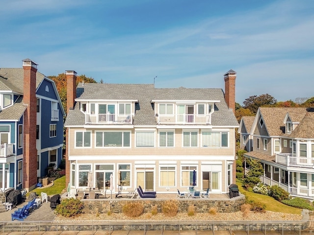 back of house with a patio and a balcony