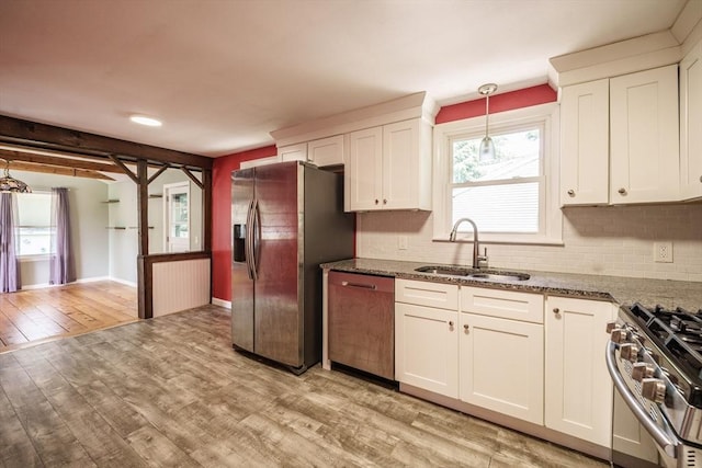226 Dutchess St, Springfield, MA 01129 - kitchen featuring stainless steel appliances, a sink, light wood-style floors, backsplash, and white cabinets