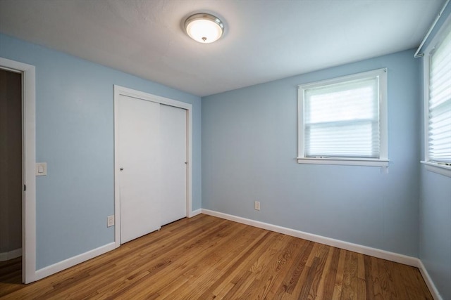 226 Dutchess St, Springfield, MA 01129 - unfurnished bedroom with wood finished floors, baseboards, and a closet
