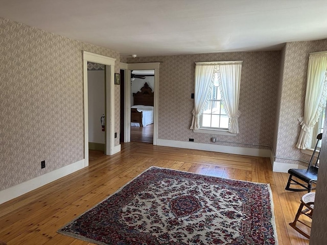 6 Weaver Farm Rd, Rutland, MA 01543 - unfurnished living room with wood-type flooring and wallpapered walls