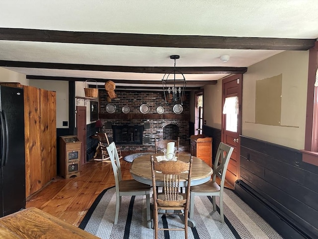 6 Weaver Farm Rd, Rutland, MA 01543 - dining area featuring a brick fireplace, hardwood / wood-style flooring, and beamed ceiling