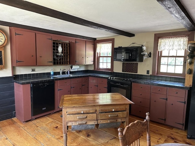 6 Weaver Farm Rd, Rutland, MA 01543 - kitchen with black appliances, beam ceiling, healthy amount of natural light, and light wood finished floors