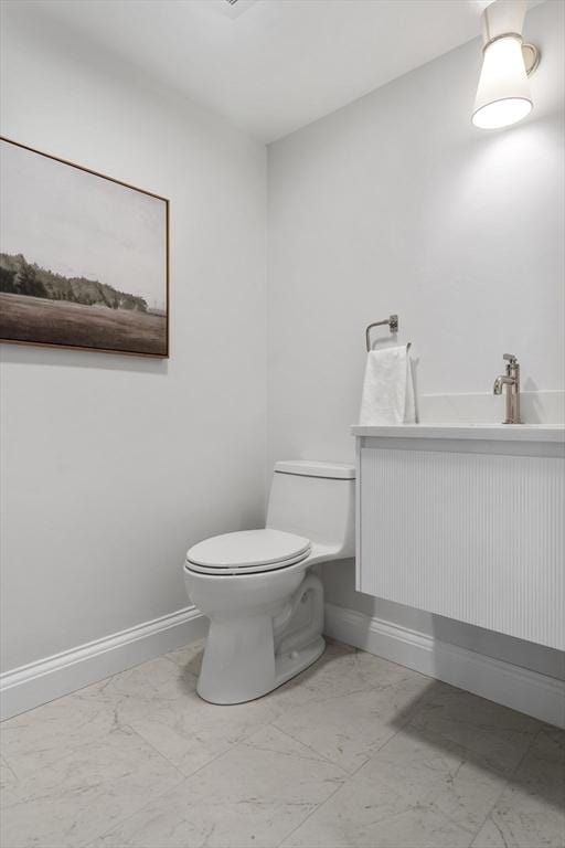 bathroom featuring toilet and vanity