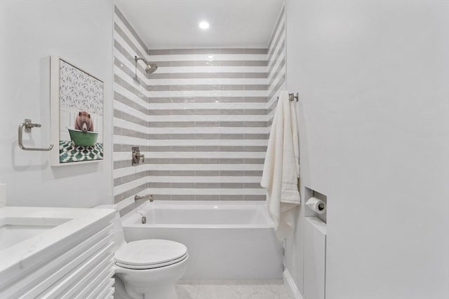 full bathroom featuring toilet, tiled shower / bath combo, and vanity