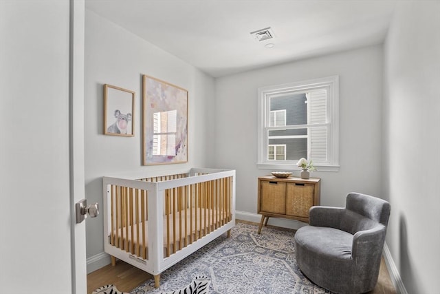 bedroom featuring a nursery area