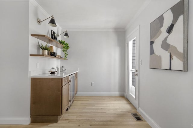 bar featuring dishwasher, light hardwood / wood-style flooring, ornamental molding, and a healthy amount of sunlight